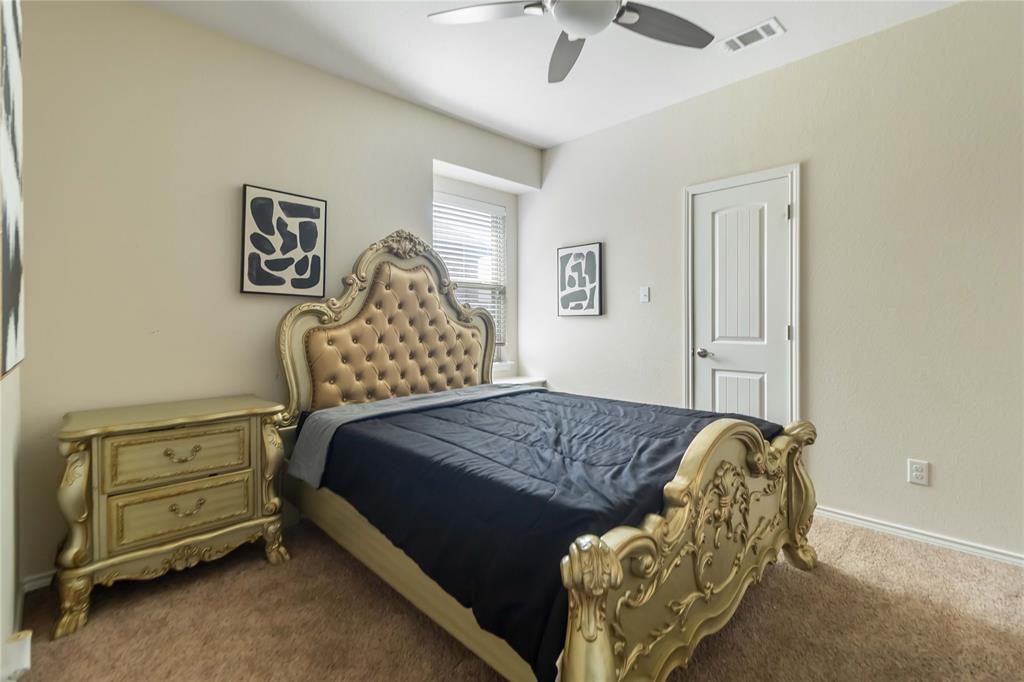 1663 Fraser Drive Burleson, TX 76028 - Photo 4 of 22 Carpeted bedroom featuring baseboards and ceiling fan