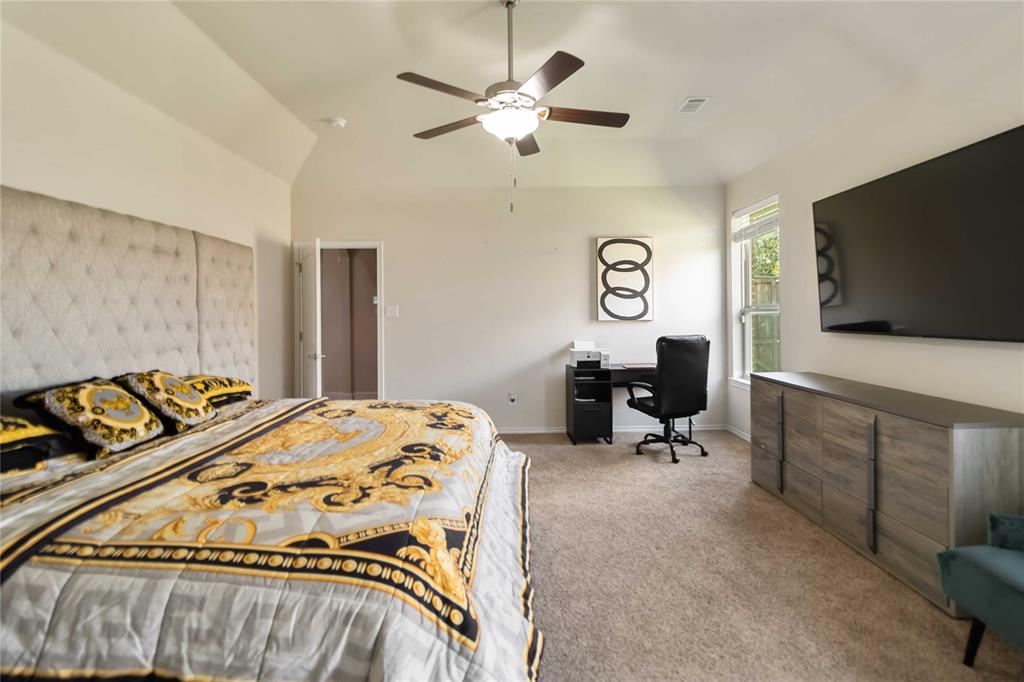 1663 Fraser Drive Burleson, TX 76028 - Photo 7 of 22 Bedroom with lofted ceiling, light carpet, an office area, and a ceiling fan