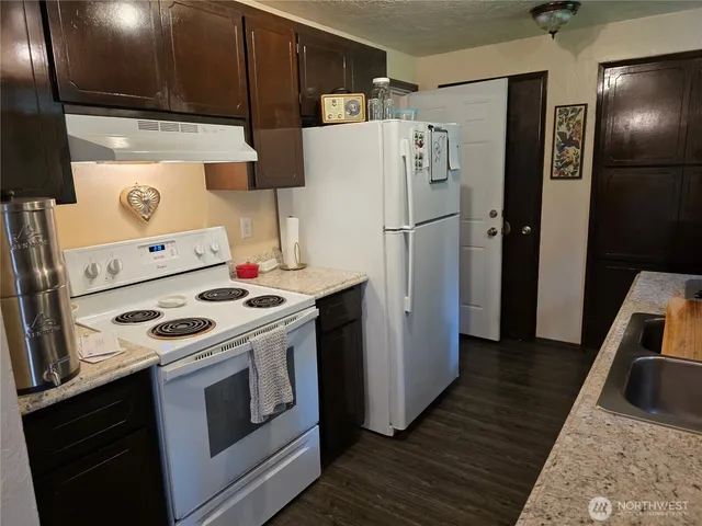 a kitchen with a stove a refrigerator and a stove