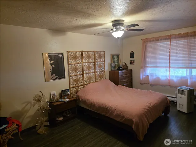 a bedroom with a bed and a chandelier