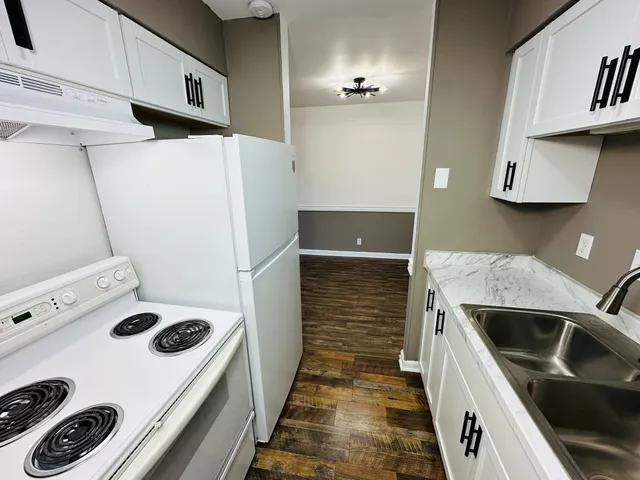 a kitchen with a refrigerator and a stove
