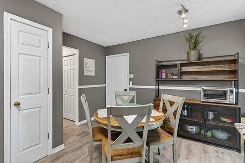 a view of a dining room with furniture and wooden floor
