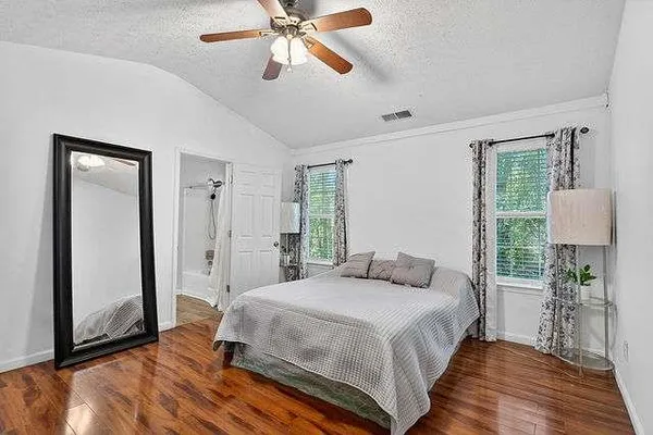 a bedroom with a bed and a mirror