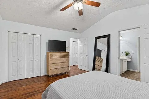 a bedroom with a bed and a flat screen tv