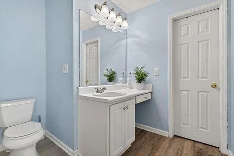 a bathroom with a toilet sink and mirror