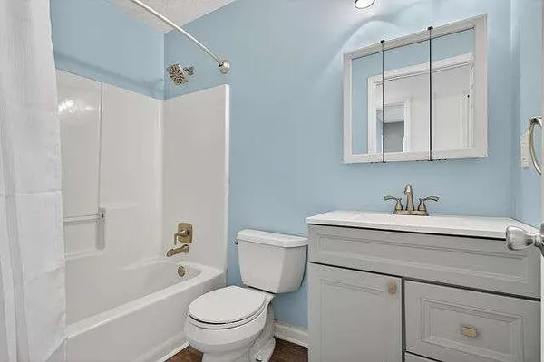 a bathroom with a granite countertop sink toilet and shower