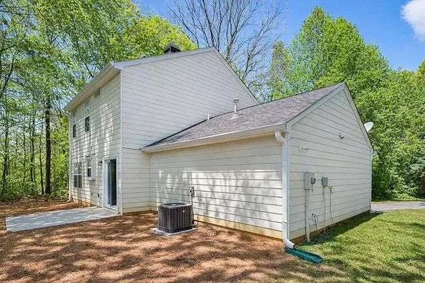 a view of a house with a backyard