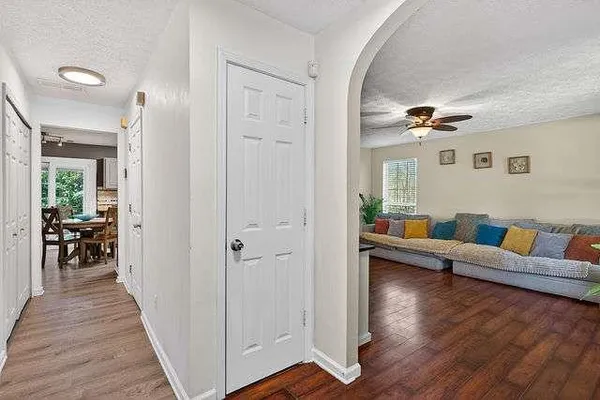 a living room with furniture and a wooden floor