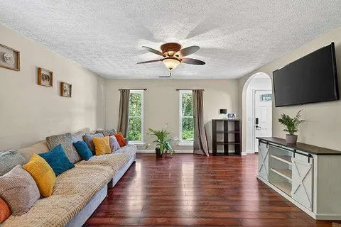 a living room with furniture and a flat screen tv