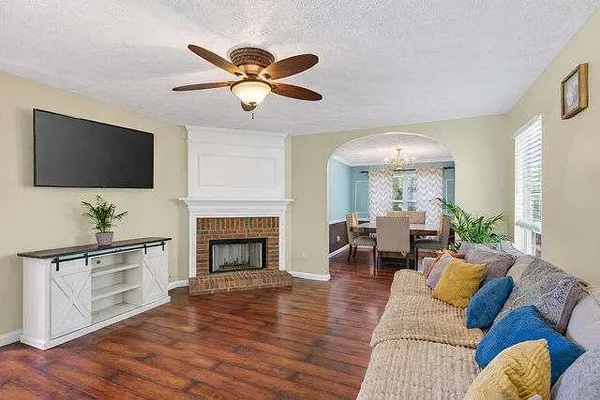 a living room with furniture fireplace and flat screen tv