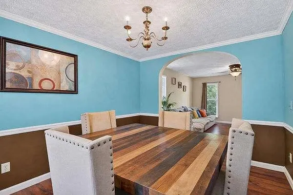 a bedroom with a large bed and a chandelier
