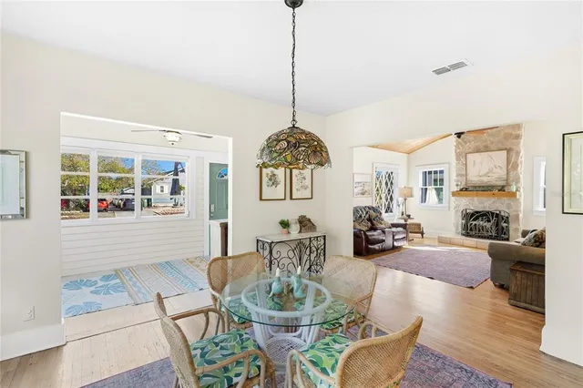 a dining room with furniture a chandelier and wooden floor