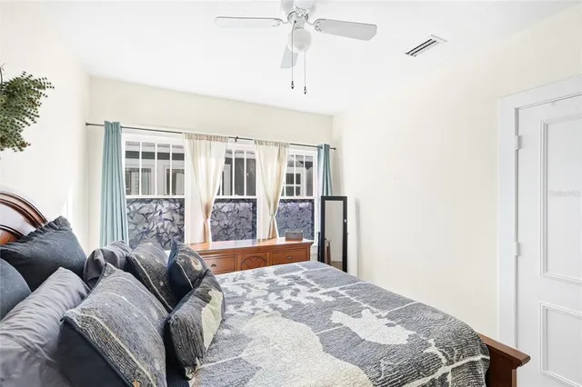 a bedroom with a large bed and a window