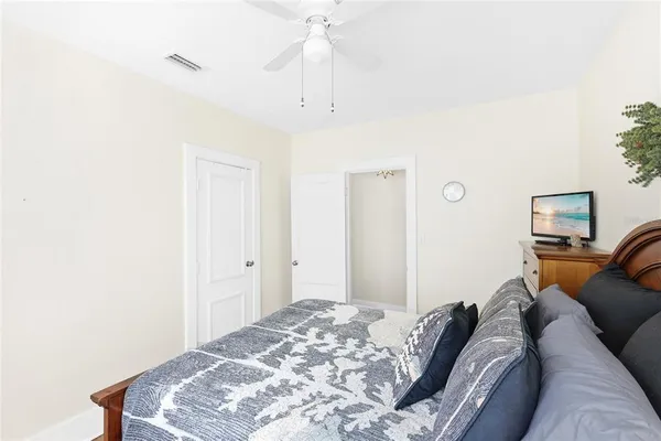 a bedroom with a bed and a lamp