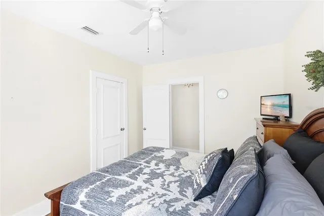 a bedroom with a bed and a lamp