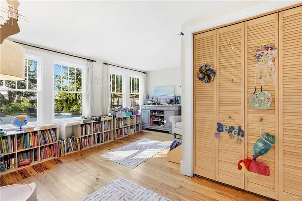 a bedroom with furniture and a book shelf