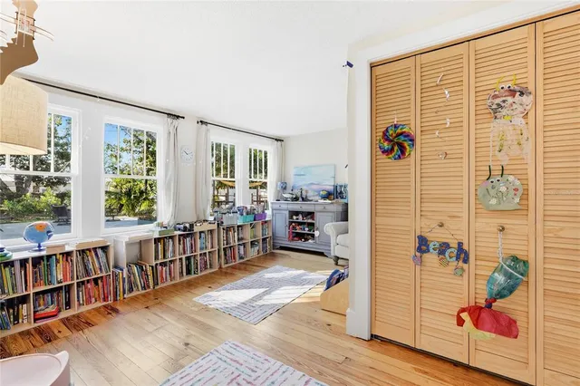 a bedroom with furniture and a book shelf