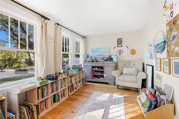 a living room with furniture and a book shelf