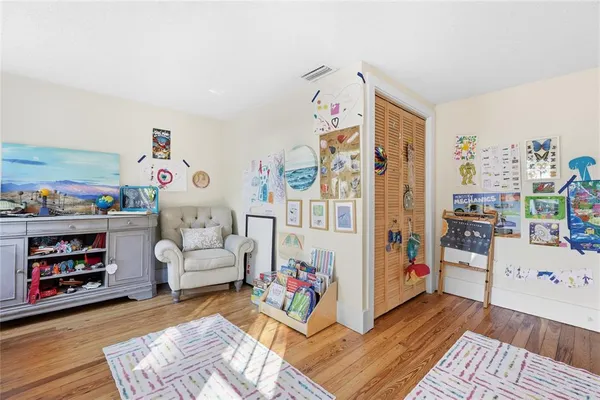 a room with furniture a baby crib and a couch