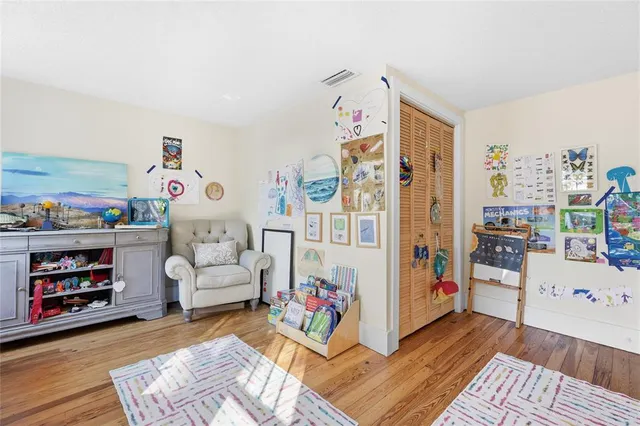 a room with furniture a baby crib and a couch