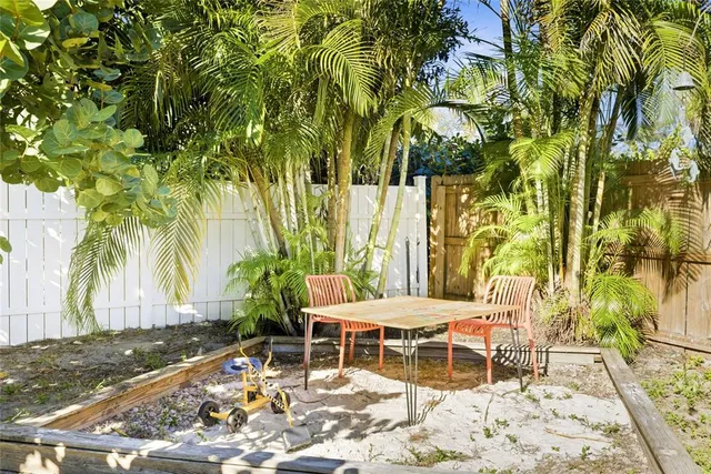 a patio with glass top table and chairs