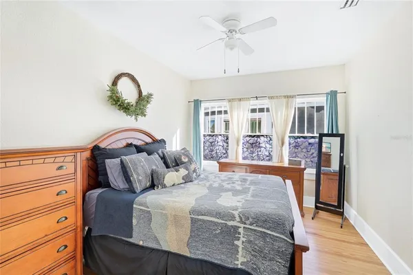 a bedroom with a large bed and a chandelier