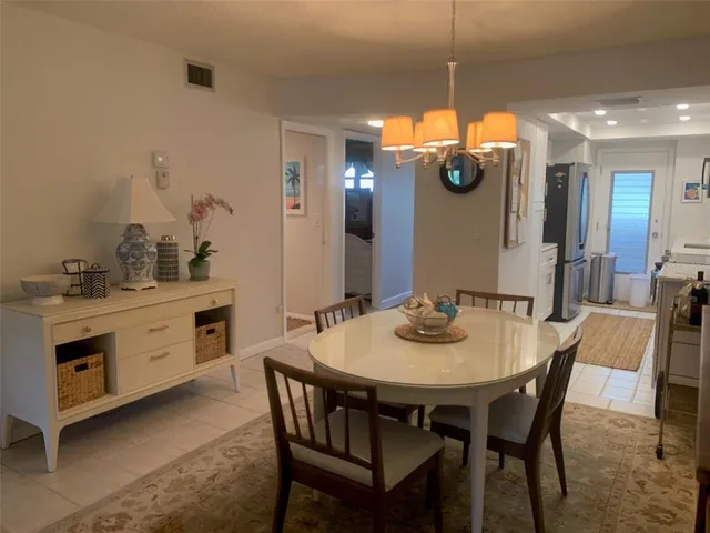 a kitchen with a dining table and chairs