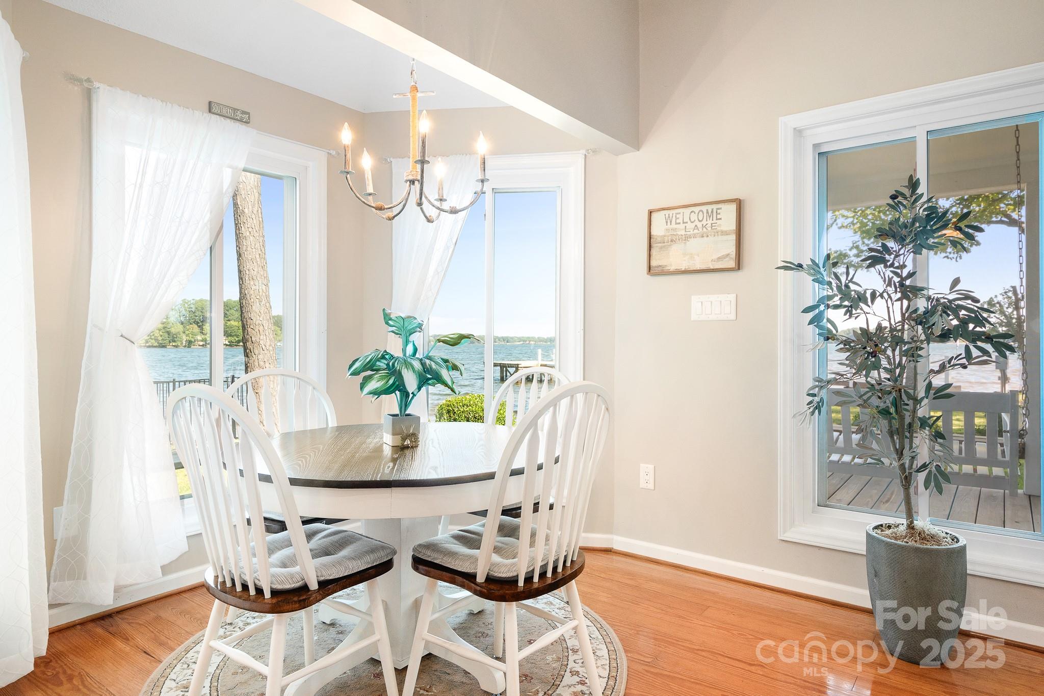 8293 Luckey Point Road Denver, NC 28037 - Photo 27 of 33 a dining room with furniture and wooden floor