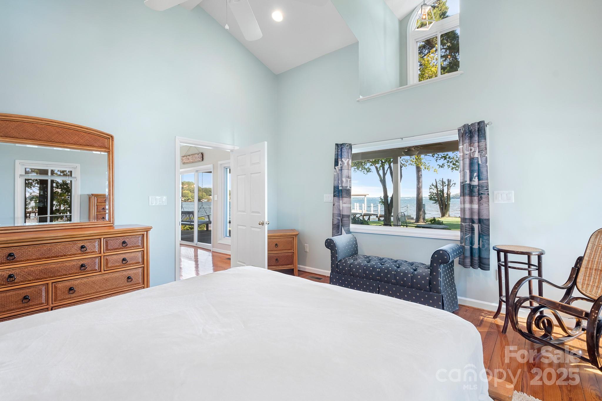 8293 Luckey Point Road Denver, NC 28037 - Photo 30 of 33 a bedroom with a bed and a large mirror