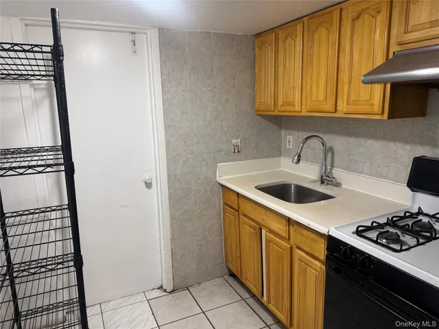 a kitchen with a sink stove and refrigerator