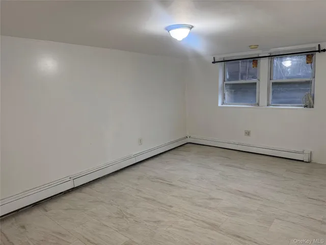 an empty room with a empty space and windows