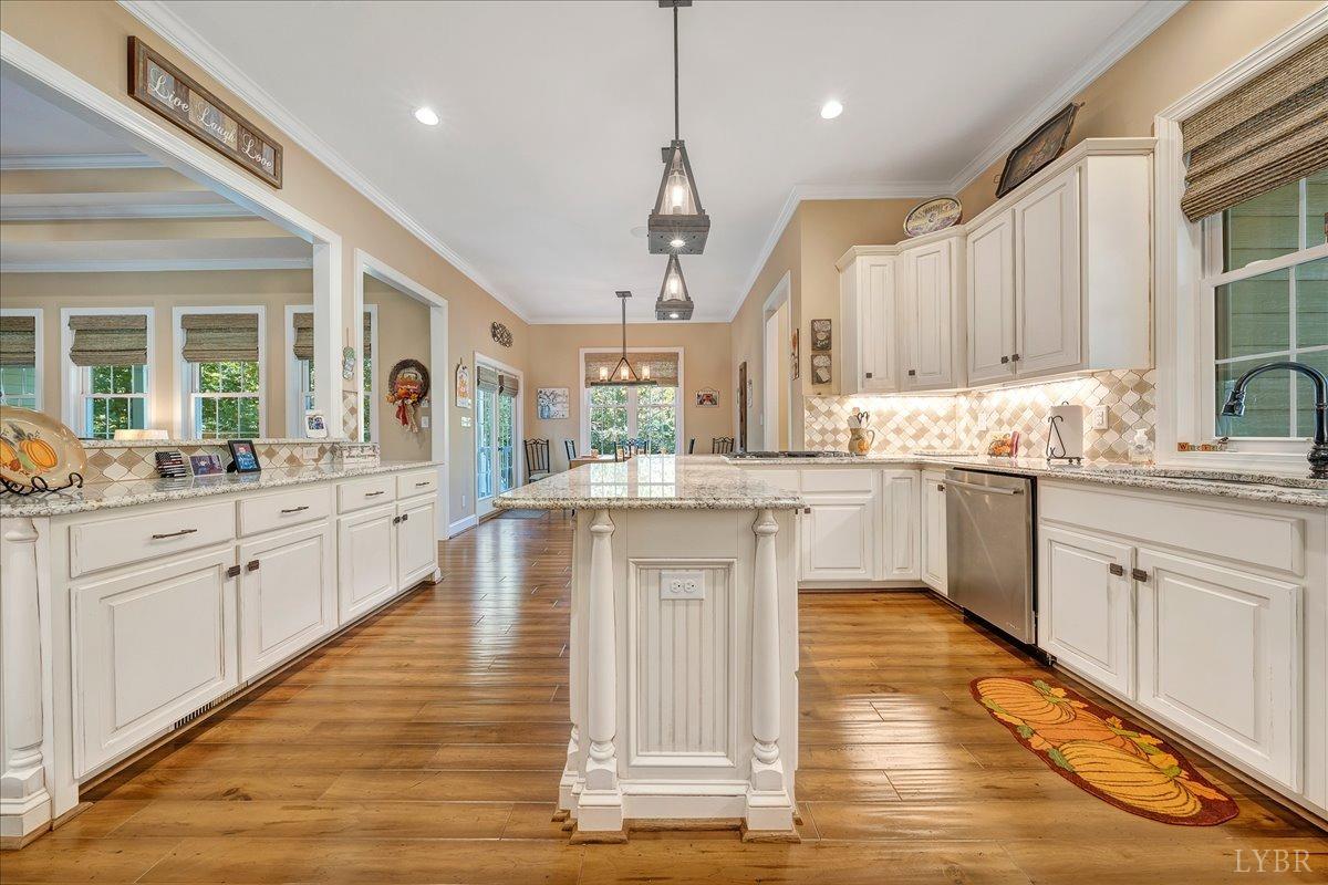 699 Police Tower Road Appomattox, VA 24522 - Photo 28 of 66 a large kitchen with granite countertop a stove top oven a sink a dining table and chairs