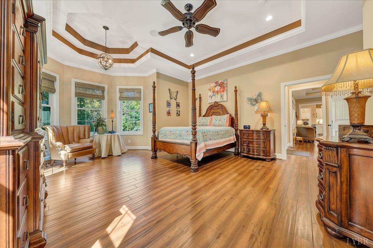 699 Police Tower Road Appomattox, VA 24522 - Photo 32 of 66 a spacious bedroom with a bed and a chandelier
