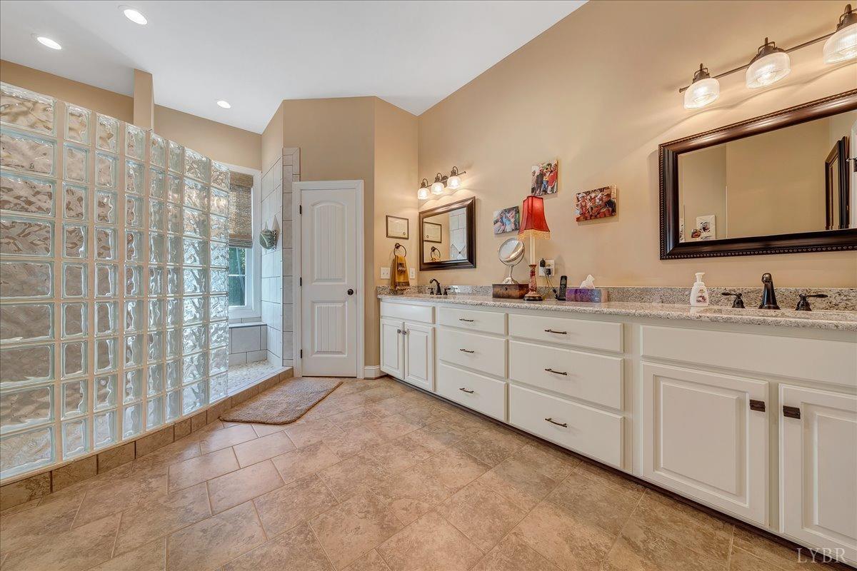 699 Police Tower Road Appomattox, VA 24522 - Photo 35 of 66 a spacious bathroom with a double vanity sink mirror and double