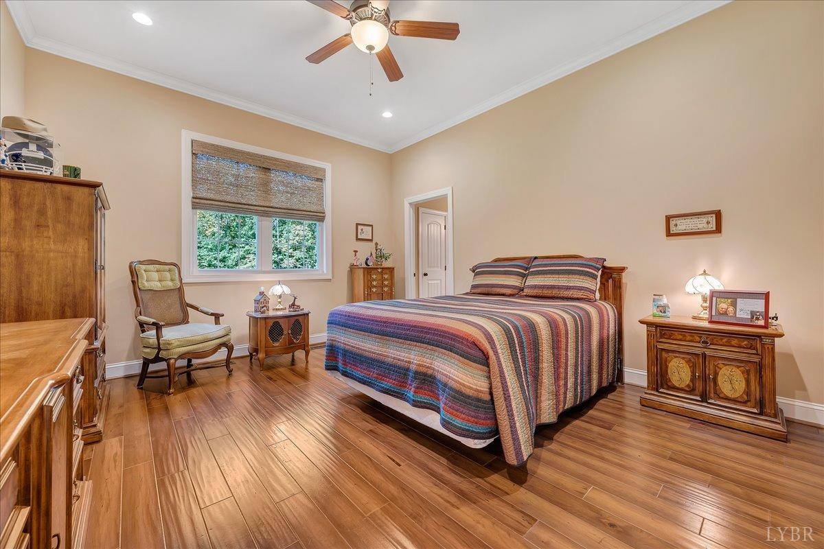 699 Police Tower Road Appomattox, VA 24522 - Photo 43 of 66 a bedroom with a bed and wooden floor