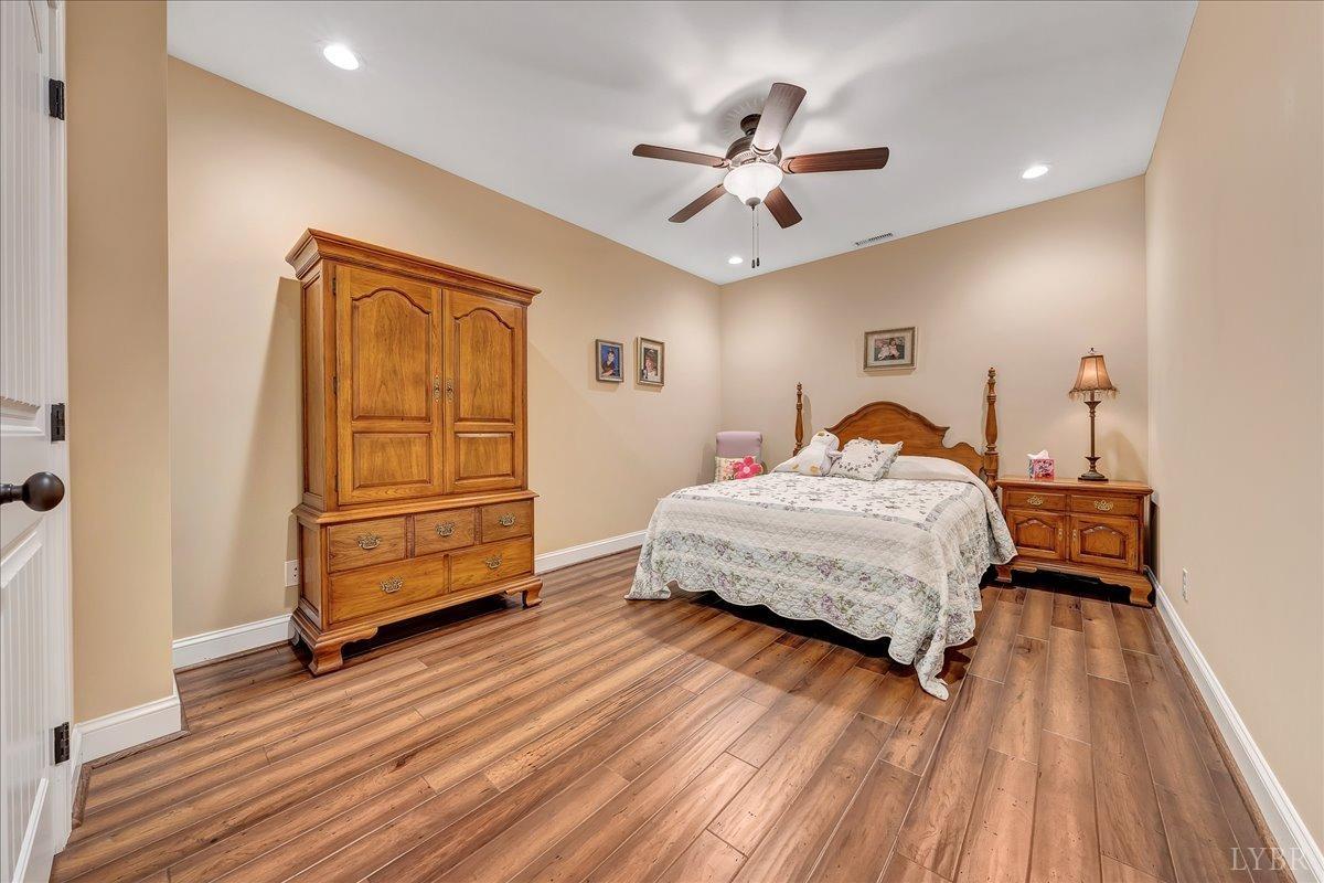 699 Police Tower Road Appomattox, VA 24522 - Photo 45 of 66 a bedroom with a bed and wooden floor
