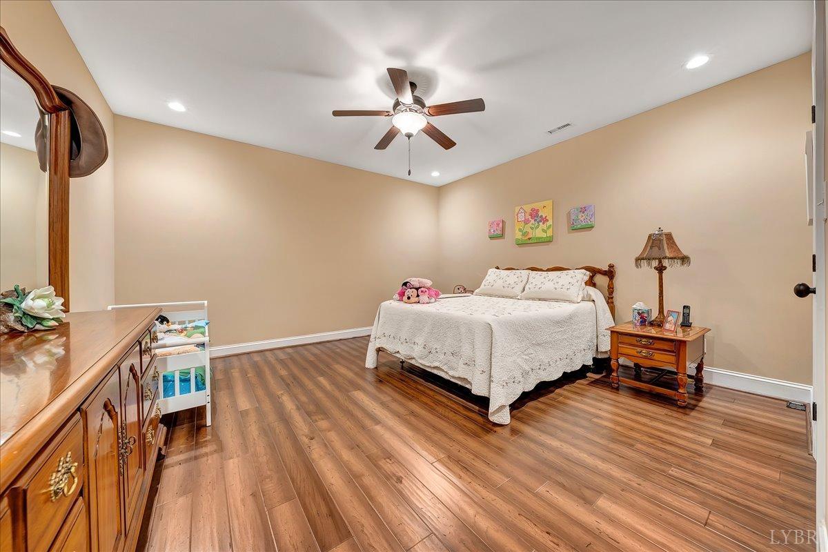 699 Police Tower Road Appomattox, VA 24522 - Photo 46 of 66 a bedroom with a bed and a chandelier