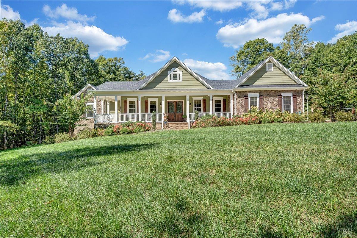 699 Police Tower Road Appomattox, VA 24522 - Photo 62 of 66 a front view of a house with a yard and trees