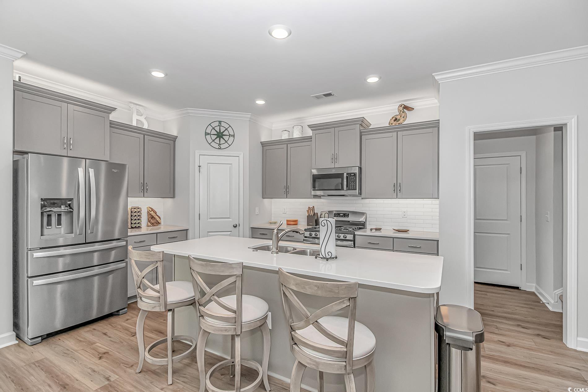 222 Sundew Loop Little River, SC 29566 - Photo 11 of 40 Kitchen with gray cabinets, a kitchen island with