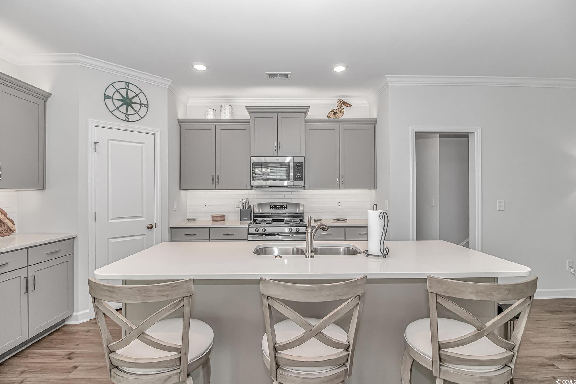222 Sundew Loop Little River, SC 29566 - Photo 12 of 40 Kitchen featuring visible vents, light wood-style
