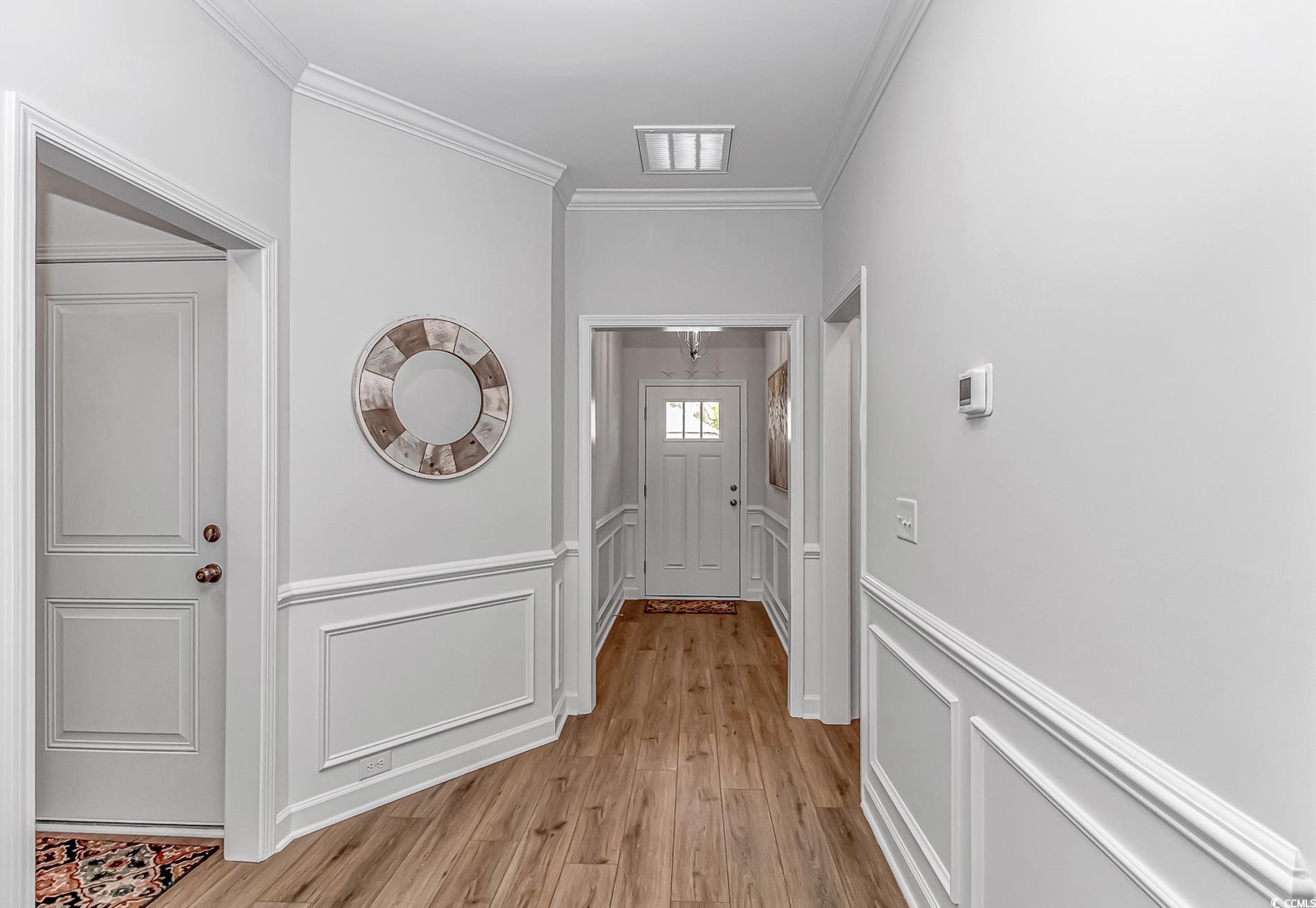 222 Sundew Loop Little River, SC 29566 - Photo 22 of 40 Hallway featuring a wainscoted wall, a decorative