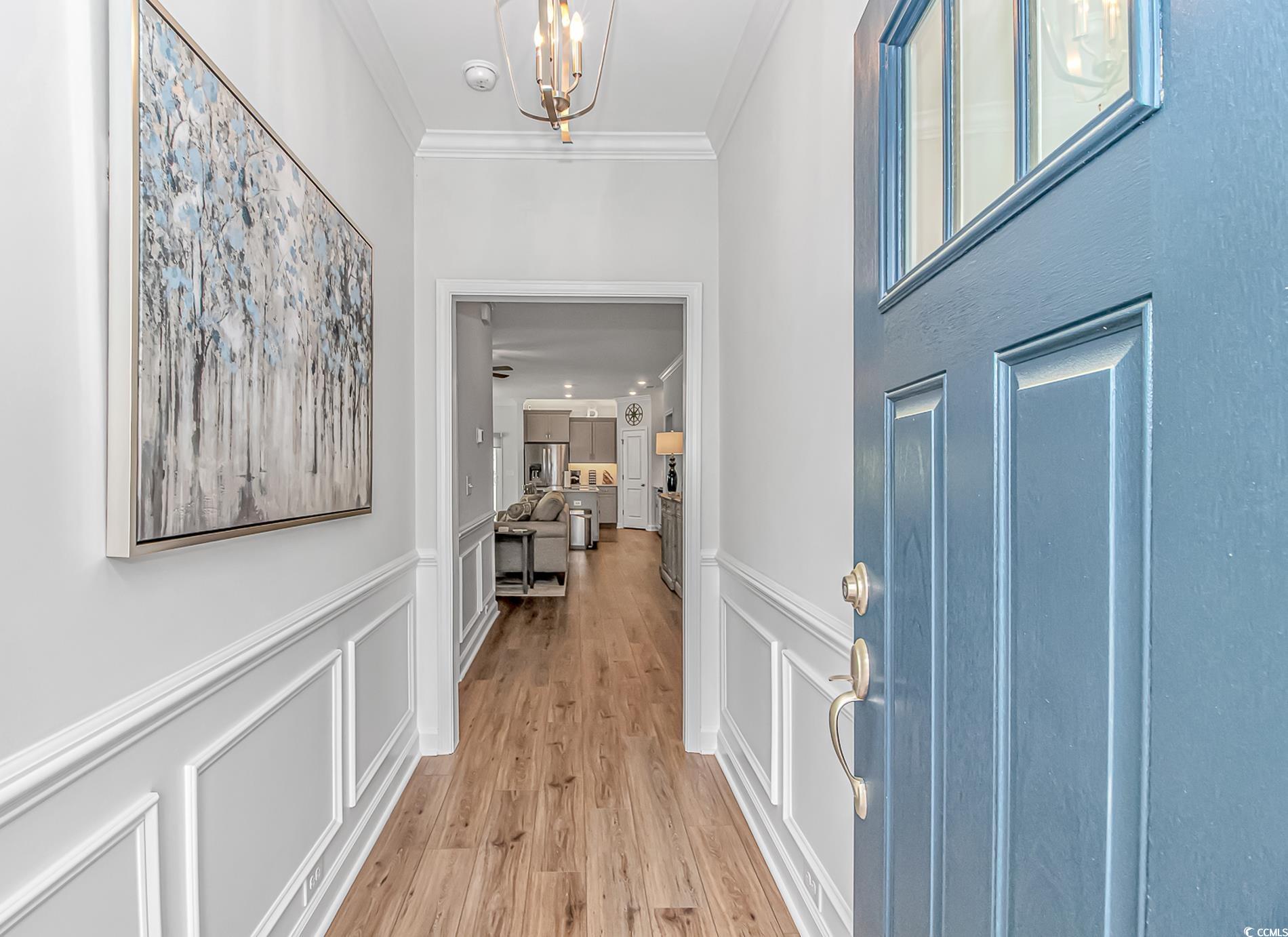 222 Sundew Loop Little River, SC 29566 - Photo 5 of 40 Foyer with a wainscoted wall, crown molding, a cha