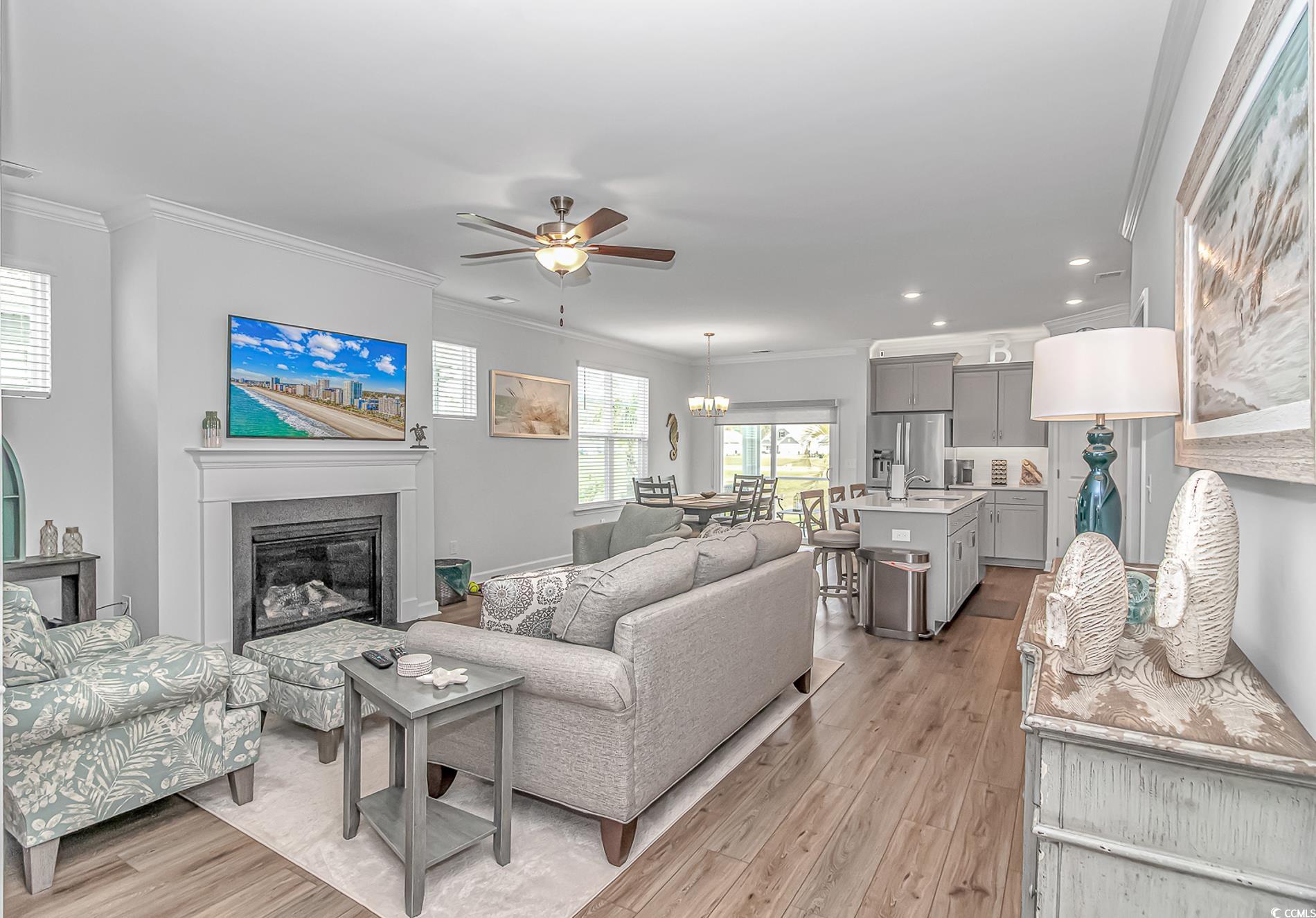 222 Sundew Loop Little River, SC 29566 - Photo 6 of 40 Living area with ornamental molding, light wood-ty