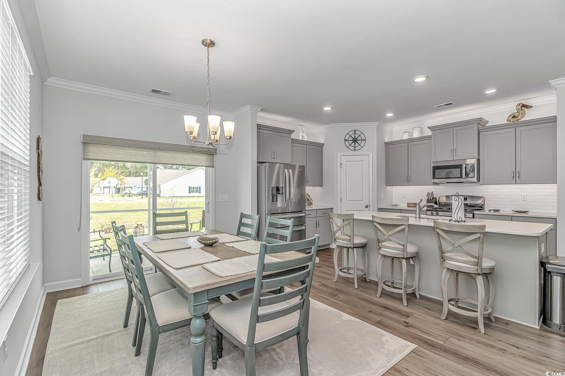 222 Sundew Loop Little River, SC 29566 - Photo 10 of 40 Dining space featuring light wood-style flooring,