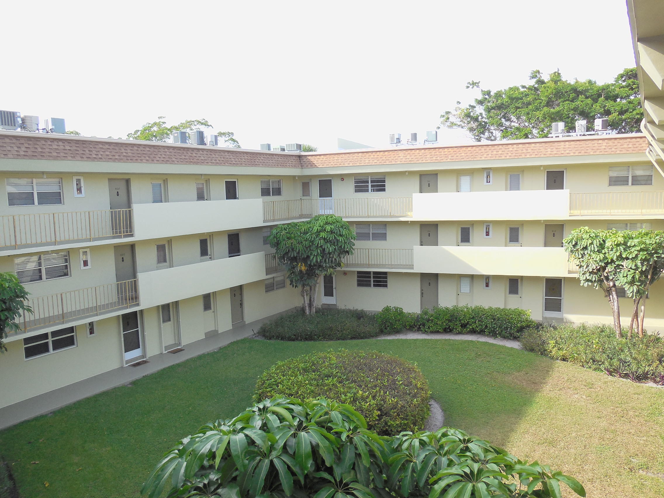 5701 Northwest 2nd Avenue, Unit 3080 Boca Raton, FL 33487 - Photo 4 of 5 a front view of a house with garden