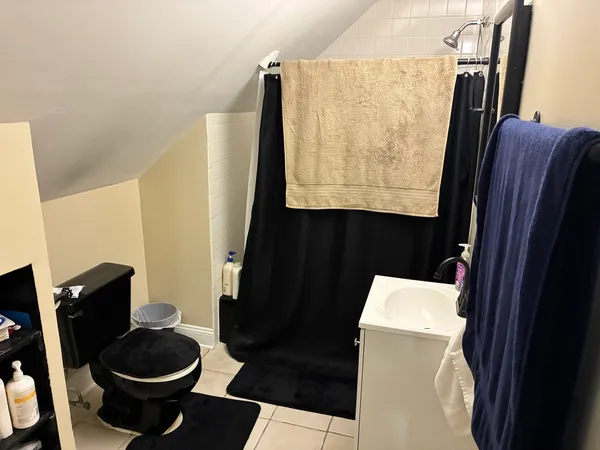 a bathroom with a sink toilet and a mirror