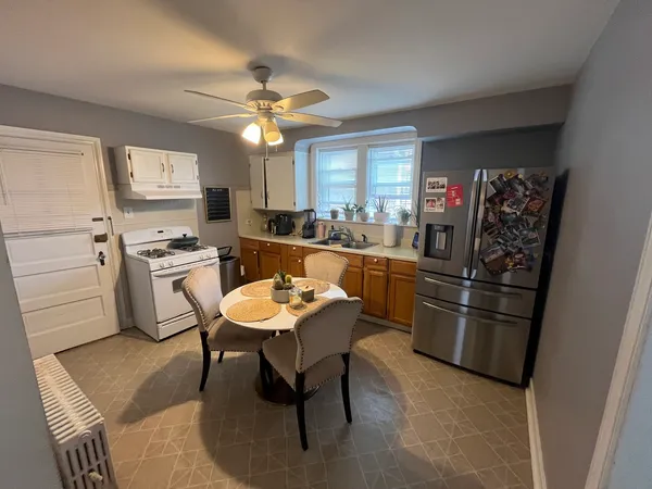 a kitchen with stainless steel appliances kitchen island granite countertop furniture and a refrigerator