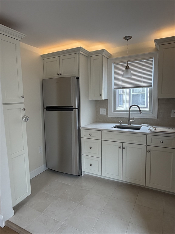 26 Brooks Street, Unit 2 Boston, MA 02128 - Photo 2 of 12 a kitchen with cabinets a refrigerator and a sink
