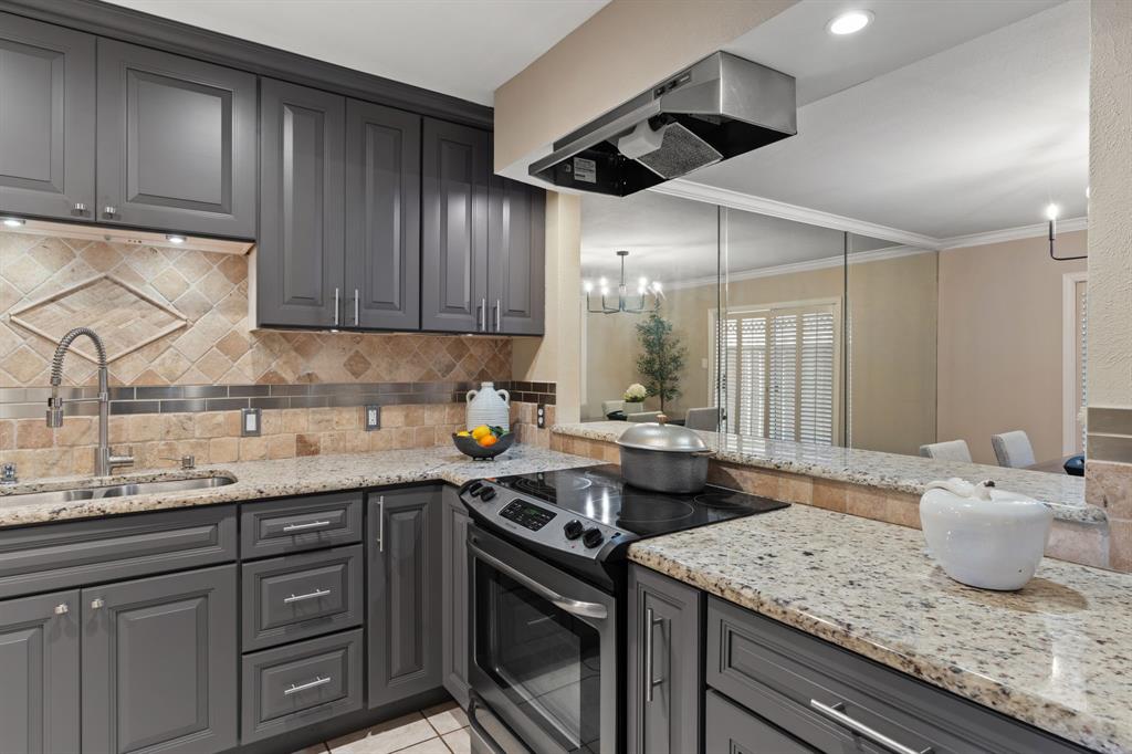15923 Preston Road, Unit 1003 Dallas, TX 75248 - Photo 12 of 36 a kitchen with a sink dishwasher stove and cabinets