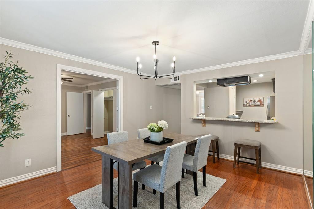 15923 Preston Road, Unit 1003 Dallas, TX 75248 - Photo 16 of 36 a view of a dining room with furniture and wooden floor